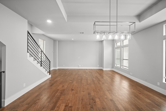 interior space featuring an inviting chandelier and dark hardwood / wood-style flooring