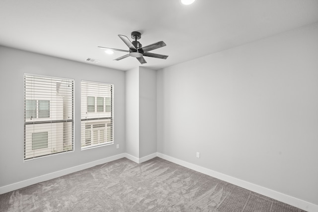 carpeted spare room with ceiling fan