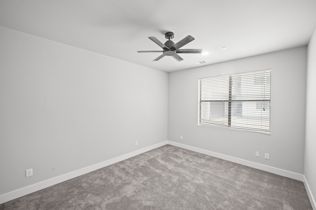 spare room featuring carpet and ceiling fan