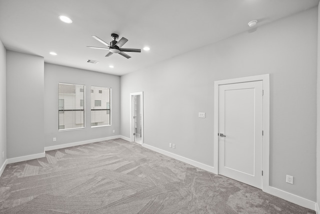 empty room featuring light carpet and ceiling fan