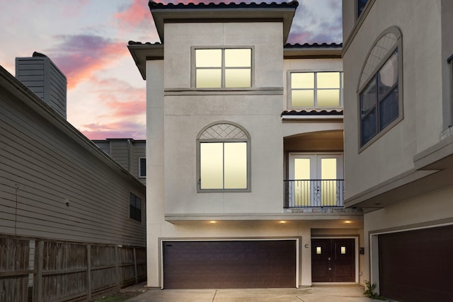 view of front of home featuring a balcony and a garage