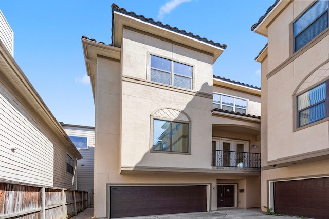 view of front of home featuring a garage and a balcony