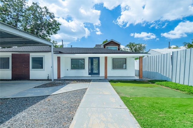 exterior space featuring a carport and a front lawn