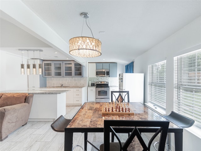 dining area with a notable chandelier and sink