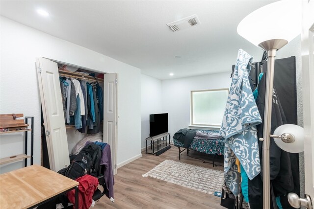 bedroom featuring hardwood / wood-style floors and a closet