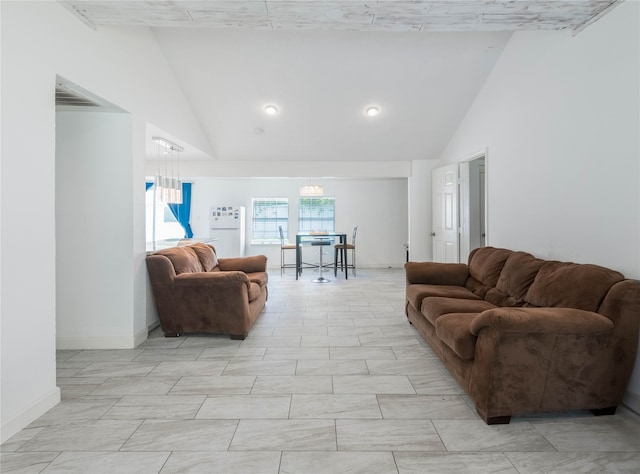 living room featuring lofted ceiling and a chandelier