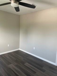 unfurnished room with ceiling fan and dark hardwood / wood-style flooring