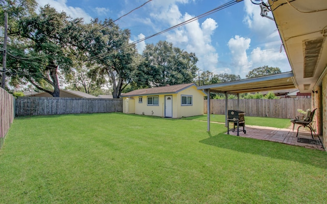 view of yard featuring an outbuilding and a patio area