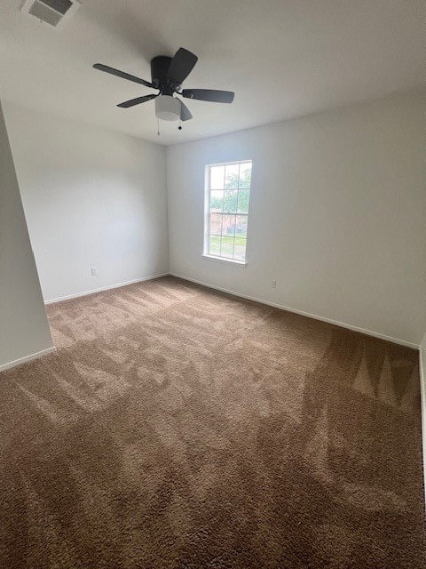 spare room with ceiling fan and carpet floors