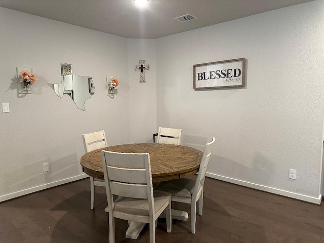 dining space with dark wood-type flooring