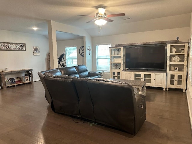 living room with ceiling fan, dark hardwood / wood-style flooring, a textured ceiling, and vaulted ceiling