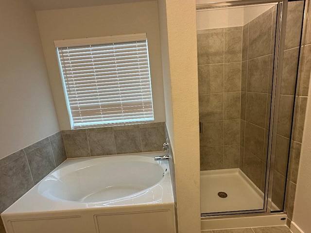 bathroom featuring plus walk in shower