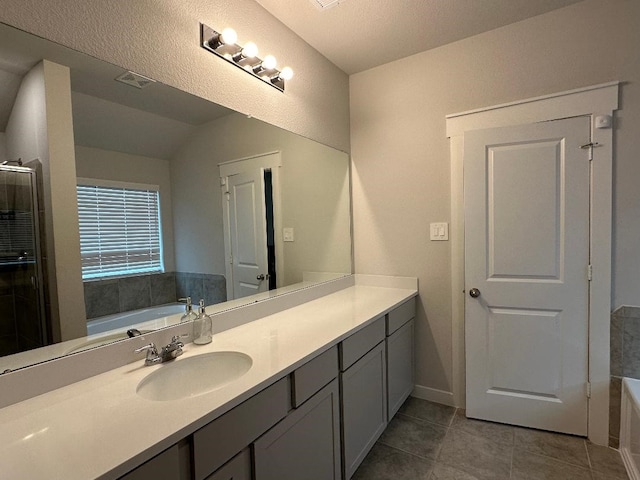 bathroom featuring tile patterned flooring, vanity, a textured ceiling, and shower with separate bathtub