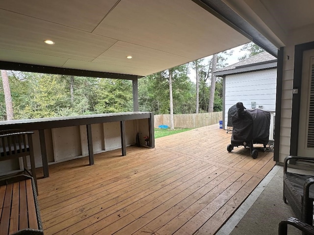 wooden deck featuring a grill