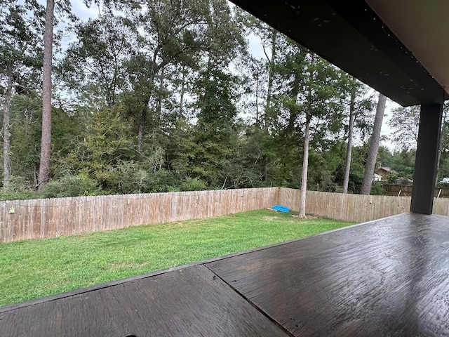 wooden terrace featuring a lawn