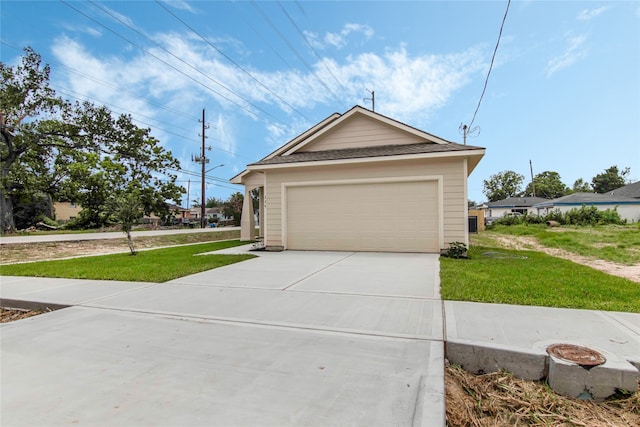 exterior space featuring a garage and a front lawn