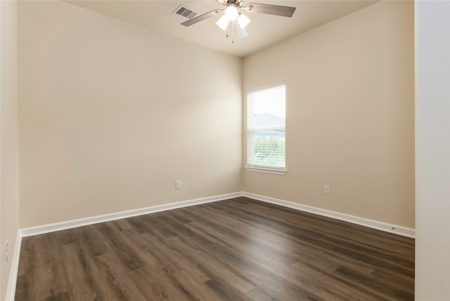 spare room with ceiling fan and dark hardwood / wood-style floors