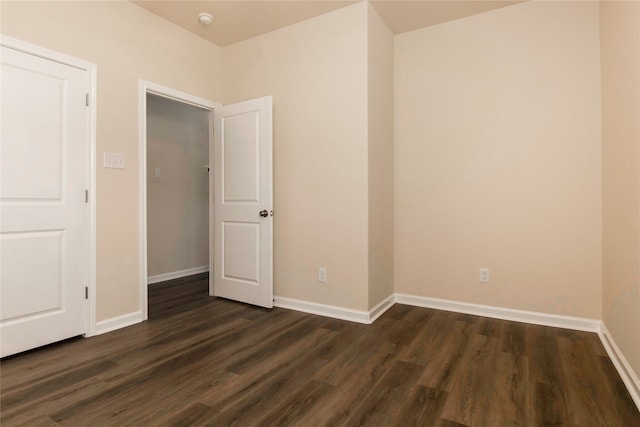 spare room with dark hardwood / wood-style flooring