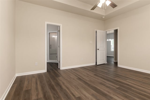 unfurnished bedroom featuring ceiling fan and dark hardwood / wood-style floors