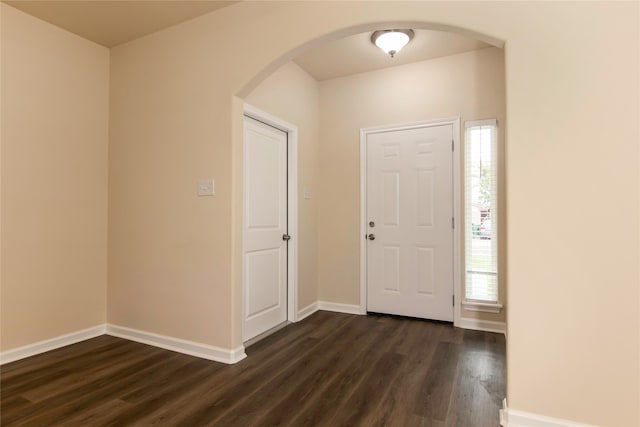 entryway with dark hardwood / wood-style flooring