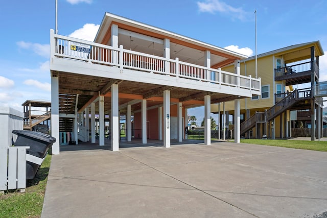 exterior space with a balcony and a carport