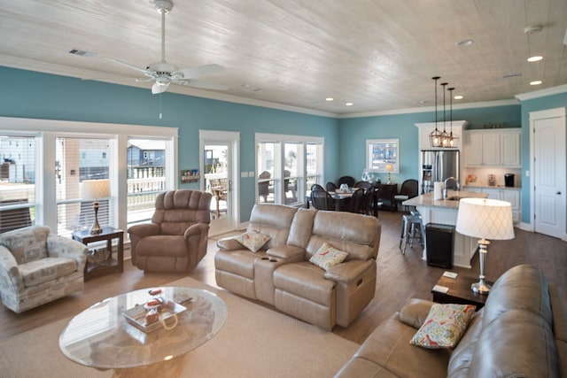 living room featuring crown molding, sink, ceiling fan, and light hardwood / wood-style flooring