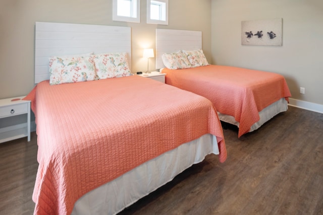 bedroom with dark hardwood / wood-style floors