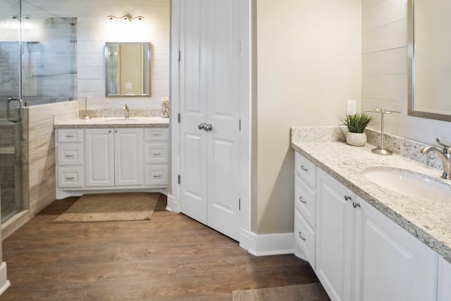 bathroom with an enclosed shower, hardwood / wood-style flooring, and vanity