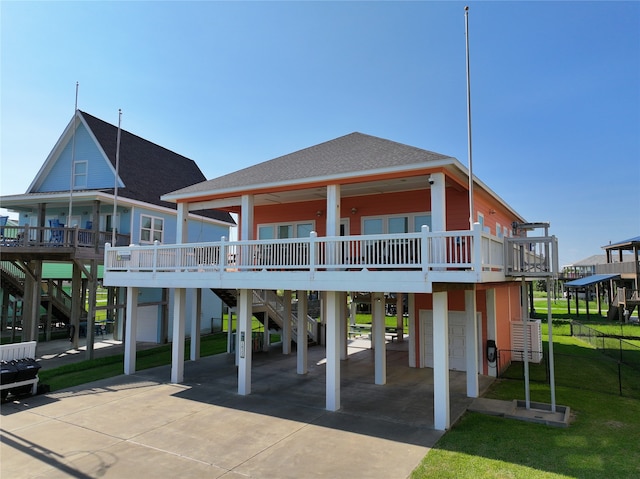 back of property with a carport, a yard, and a garage