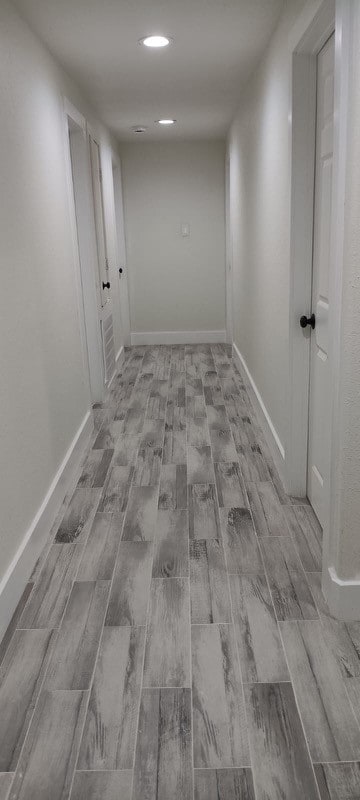 hallway with light hardwood / wood-style floors