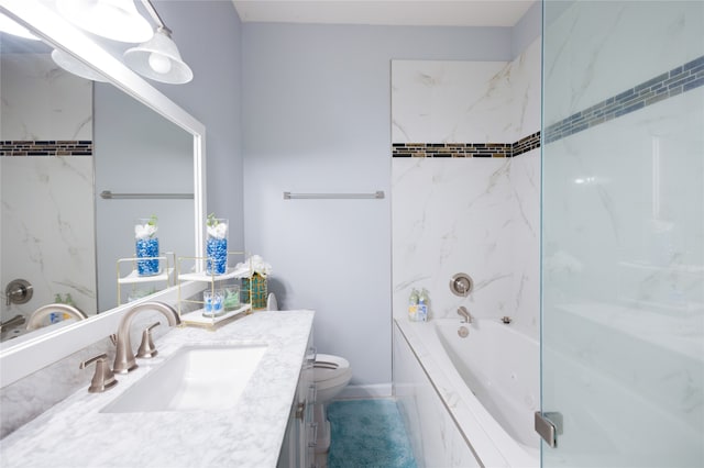 full bathroom featuring tiled shower / bath, toilet, and vanity