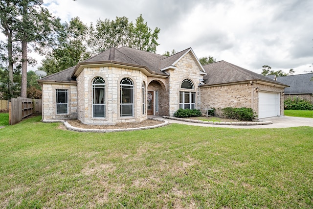 french provincial home featuring a garage and a front lawn