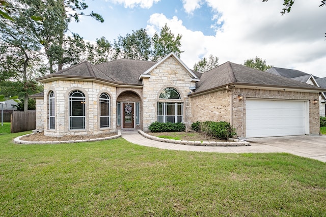 view of front of house featuring a garage and a front lawn