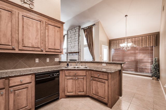 kitchen with vaulted ceiling, sink, dark stone countertops, dishwasher, and a chandelier