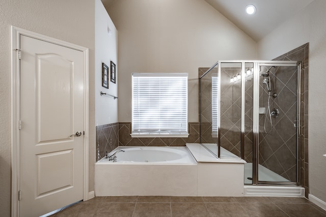 bathroom with tile patterned floors, lofted ceiling, and independent shower and bath