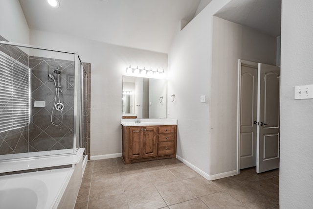 bathroom featuring plus walk in shower, vanity, and tile patterned floors