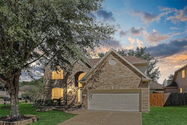 view of front of property featuring a lawn and a garage