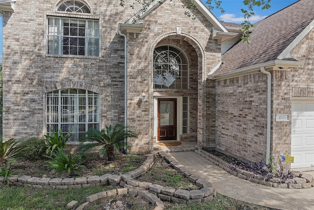 doorway to property with a garage