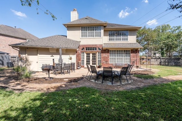 rear view of house featuring a patio and a yard