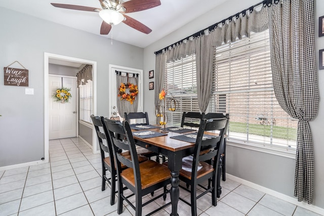 dining space with light tile patterned floors and ceiling fan