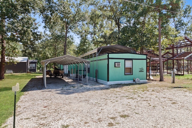 view of outbuilding with a yard and a carport