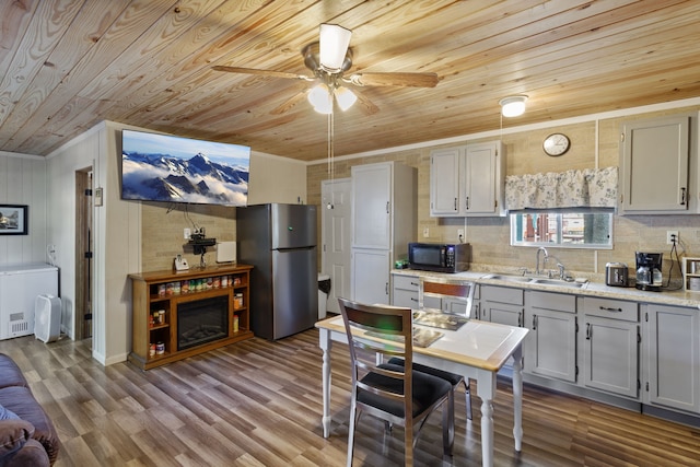 kitchen with wood ceiling, sink, stainless steel fridge, ceiling fan, and ornamental molding