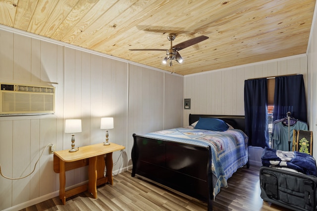 bedroom with wooden ceiling, light hardwood / wood-style flooring, a wall unit AC, and ceiling fan