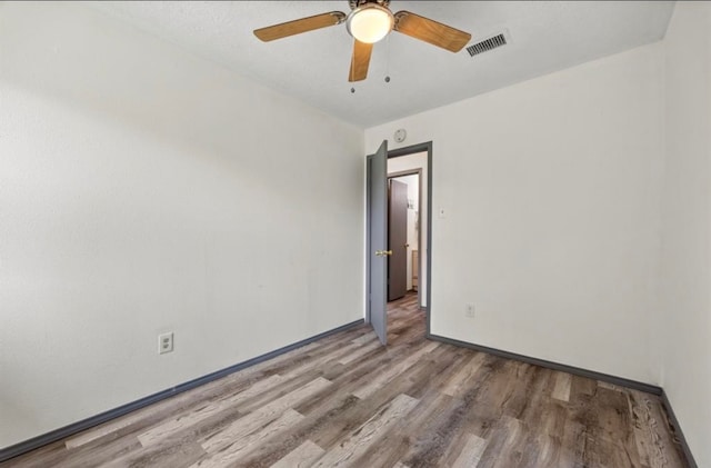 spare room with ceiling fan and hardwood / wood-style floors