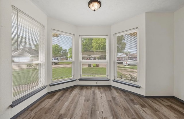 unfurnished dining area with hardwood / wood-style flooring