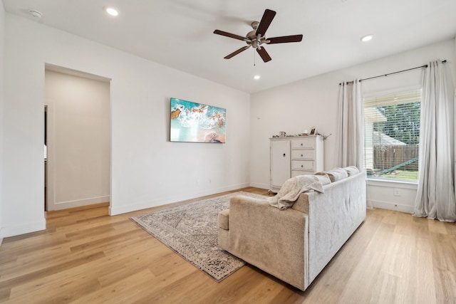 living room featuring light wood-type flooring and ceiling fan