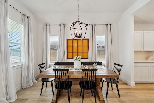 dining room with light hardwood / wood-style floors, a chandelier, and plenty of natural light