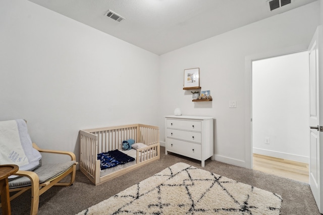 bedroom featuring a nursery area