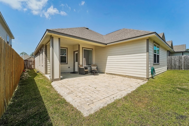 back of property featuring a patio area and a yard