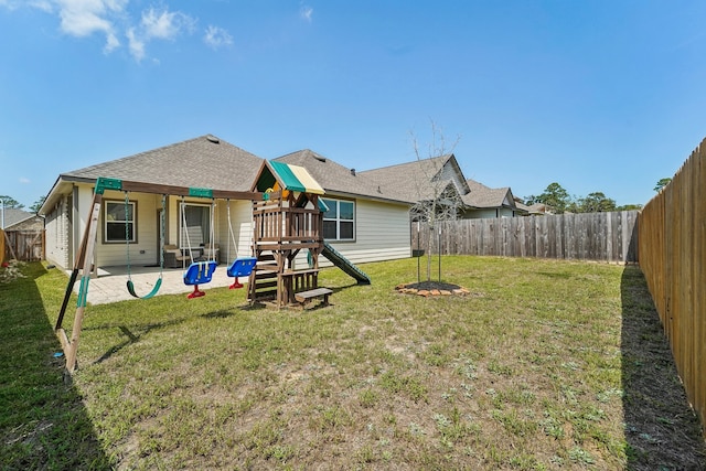 back of property with a yard and a patio area